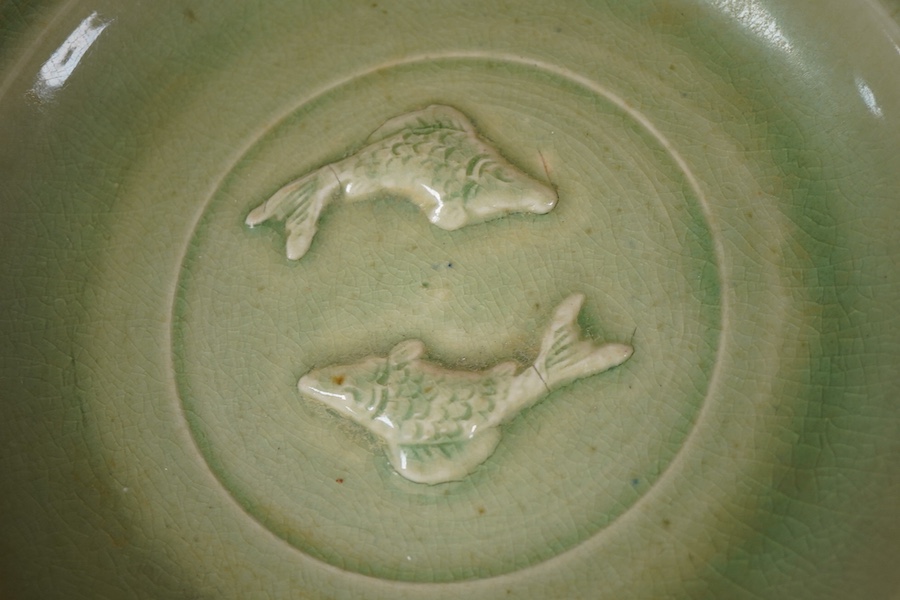 A South East Asian celadon glazed twin fish dish, 26cm diameter